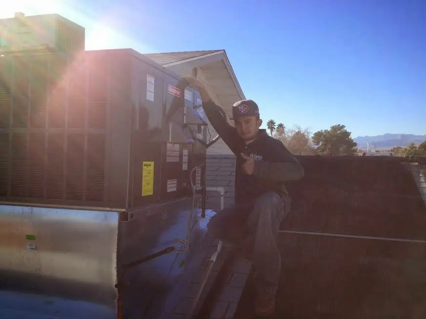 HVAC technician performing AC Tune-Up on a rooftop unit in North Middleton
